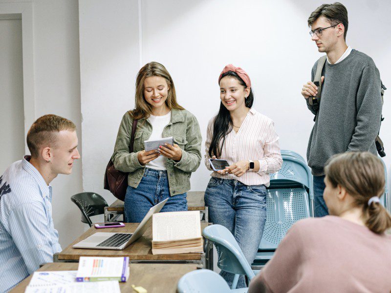 A group of people standing around a table.