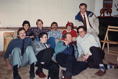 A group of people sitting on the floor together.